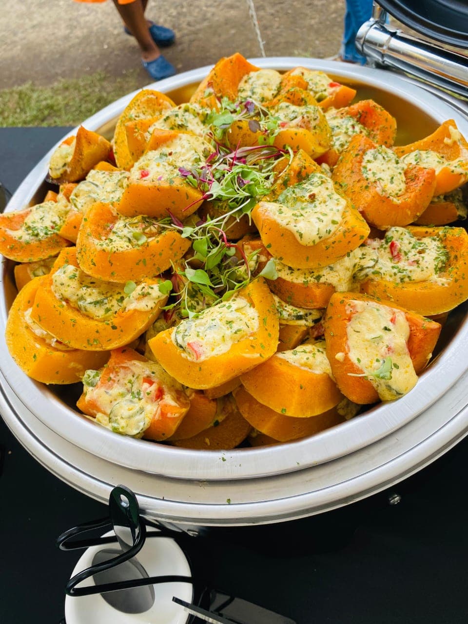 Roasted butternut wedges with herb topping, garnished with microgreens