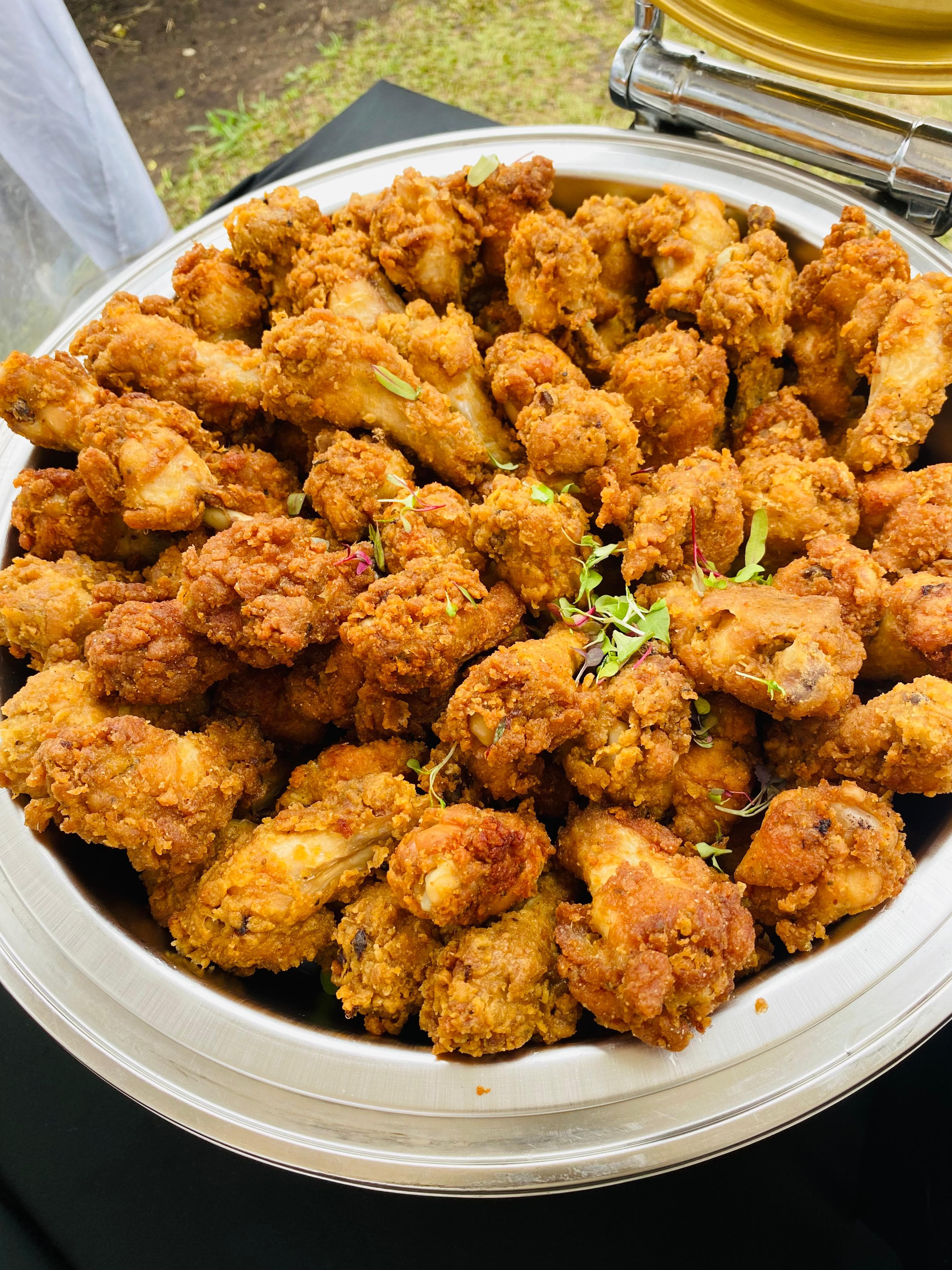 Golden fried chicken pieces in a serving dish