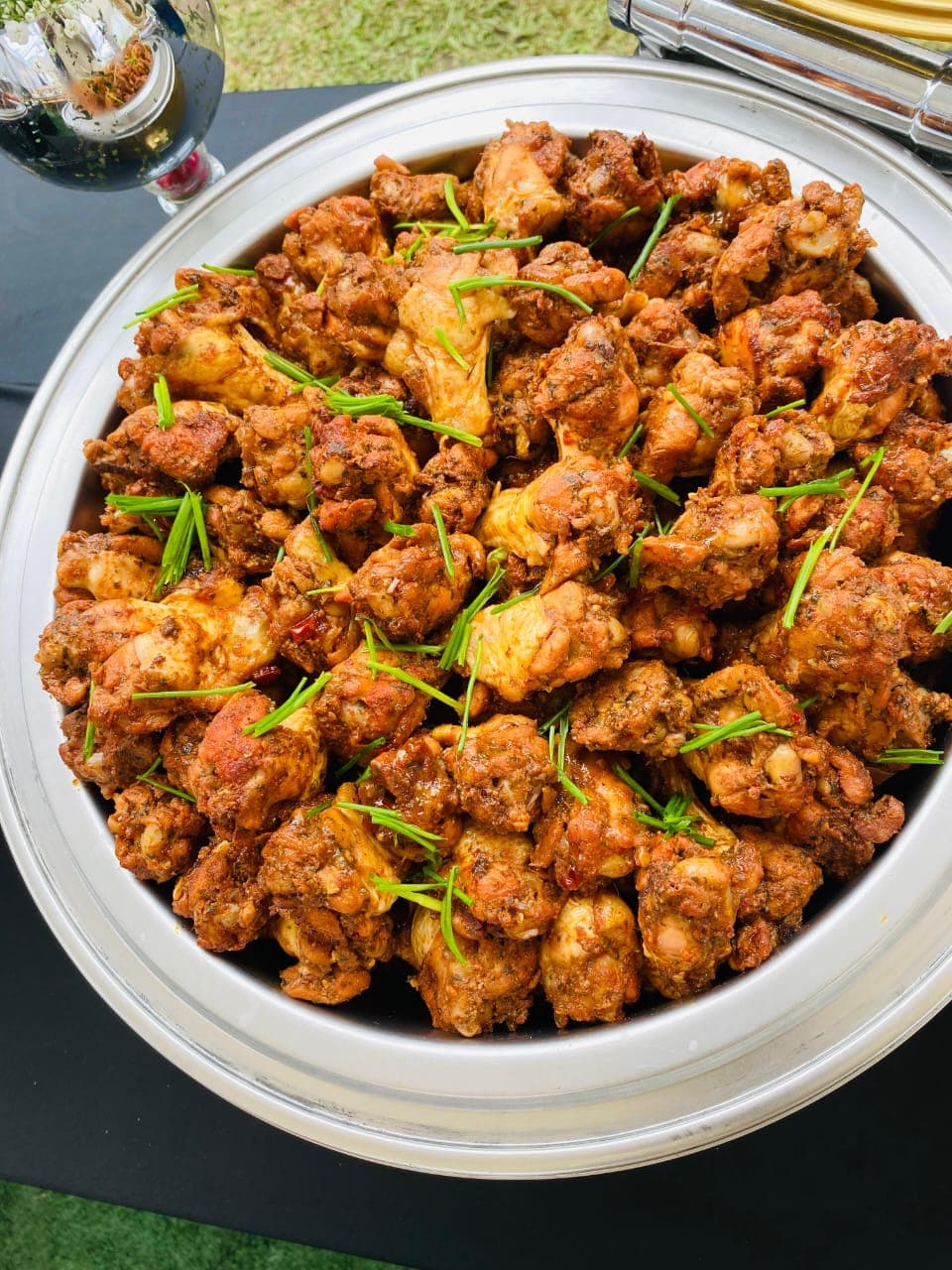 Marinated chicken pieces garnished with chives